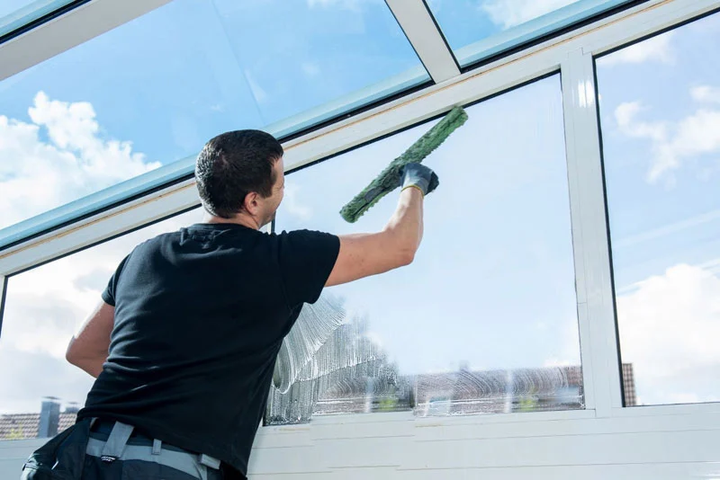 Professional window cleaner at work